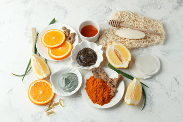Homemade skin care and body scrub and mask with natural ingredients honey, lemon, clay, coffee grain, aloe vera, oranges set up on white background