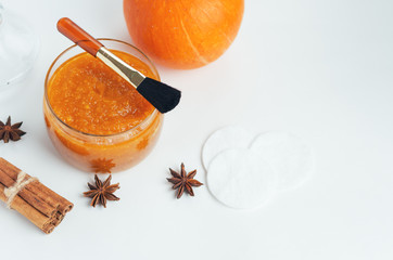 Homemade pumpkin face mask . Home cosmetics with their hands , brush for application on a white background