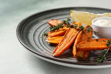 Plate with tasty cooked carrot on table, closeup