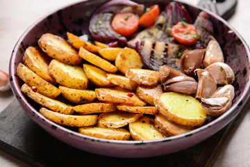 Plate with tasty baked potato on table