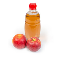 Bottle of the traditional apple cider and two fresh apples