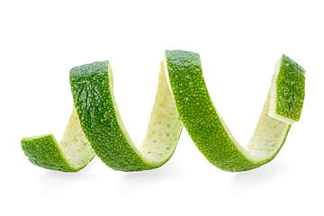 Lime peel in spiral form on a white background, healthy food.