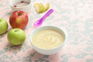 Bowl with healthy baby food on table