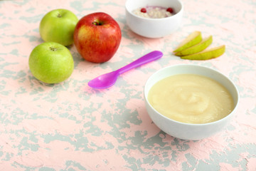 Bowl with healthy baby food on table