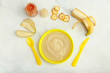 Plate with healthy baby food on table