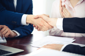 Business people shaking hands finishing up a meeting. Handshake at successful negotiation