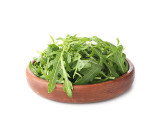 Plate with fresh arugula on white background