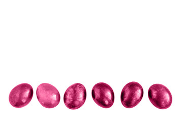Pink Easter eggs in a row on isolated white background.