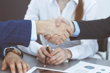 Obraz premium Business people shaking hands, finishing up a papers signing. Meeting, agreement and lawyer consulting concept