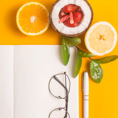 Summer workplace layout with notepad and fruit