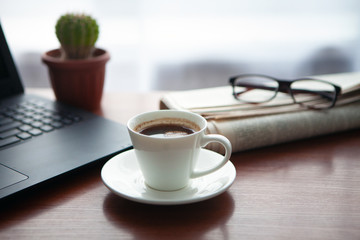 Newspaper with computer on table. Coffee break. 