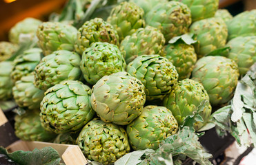 Fototapeta premium Fresh artichokes on market counter
