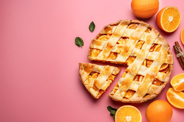Tasty orange pie on color background