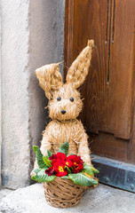 delicate handmade easter bunny rabbit made out of straw and reeds as creative Easter decoration
