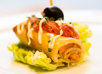 pincho roll with olives on salad leaf