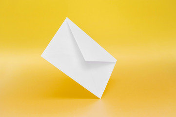Blank white paper envelope on a single-colored background