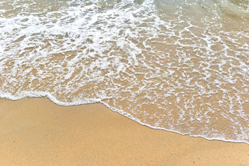 Fototapeta na wymiar Soft motion waves on the sandy beach