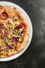 Restauran pizza on dark marble, copy space