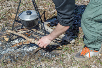 Cooking on a fire at spring. Close view of caldron over the campfire.