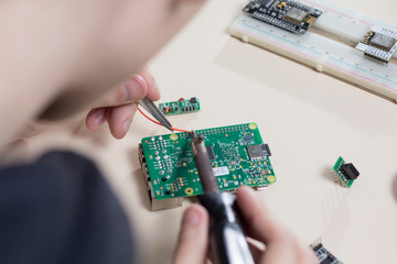 Fototapeta na wymiar a man soldering parts