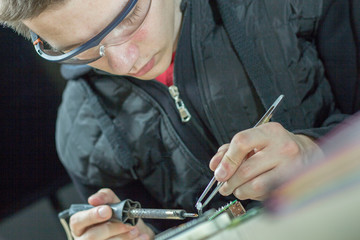 a man soldering parts