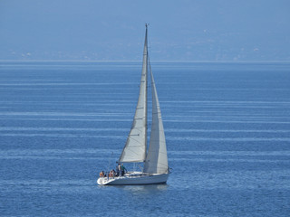 Zoom photo of sail boat sailing the Aegean deep blue sea