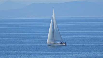 Fototapeta premium Zoom photo of sail boat sailing the Aegean deep blue sea