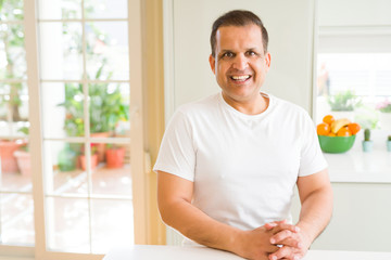 Middle age man smiling confident to the camera at home