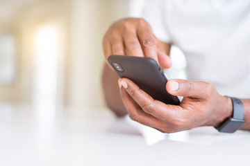 Close up of african american man hands using smartphone