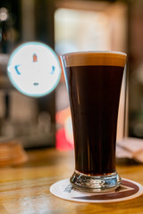 Close up shot of a glass of dark beer
