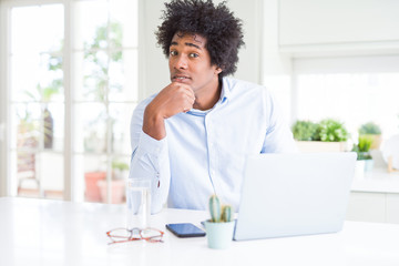 African American business man working using laptop serious face thinking about question, very confused idea