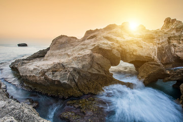 Sunset over rocky coast in Calabria