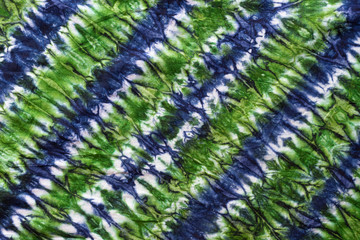 colorful tie dye pattern hand dyed on cotton fabric abstract background.