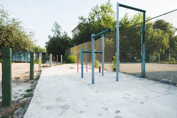 children's playground with swings in courtyard of residential building in the city