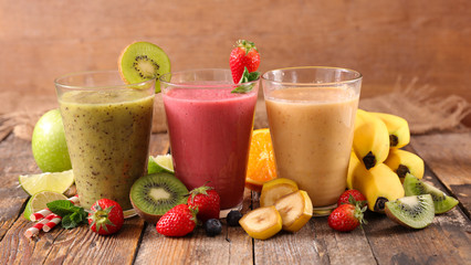 assorted fruit juice, smoothie on wood background