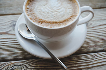 cup of coffee on wooden table