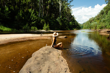 Woman relaxing along the shallows of the Grose River