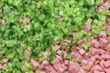 cucumbers and sausage cut for salad, background and texture close-up