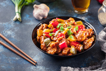 Sweet and sour chicken with colorful bell pepper on a plate