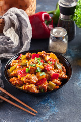 Sweet and sour chicken with colorful bell pepper on a plate