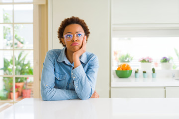 Young beautiful african american woman wearing glasses thinking looking tired and bored with depression problems with crossed arms.