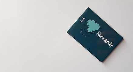 The inscription on the magnet I love Normandy on a white background.
