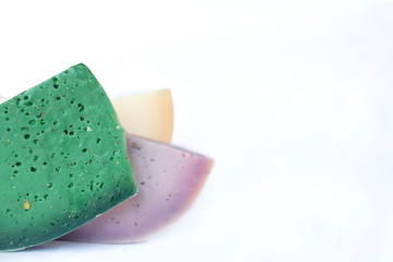 Assortment of gouda cheeses close-up on a white background, copy space
