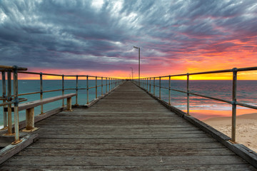 Fototapeta na wymiar A vibrant sunset at the Port Noarlunga Jetty South Australia on 15th April 2019