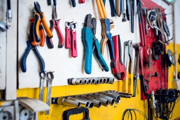 Close-up photo of pliers tools inside the car mechanic shop. Set of tools. Car repair equipment.