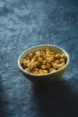 Bowl chickpea close up on dark stone background with copy space