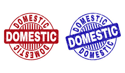 Grunge DOMESTIC round stamp seals isolated on a white background. Round seals with grunge texture in red and blue colors. Vector rubber imprint of DOMESTIC text inside circle form with stripes.