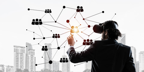 Handsome businessman experiencing impressive virtual reality connection concept