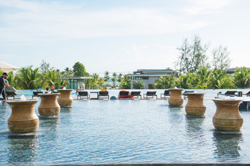 PHU QUOC, VIETNAM JUNE 28, 2017: Swimming pool with stair and wooden deck at hotel.
