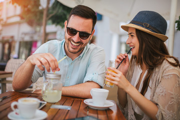 Beautiful loving couple sitting in a cafe enjoying in coffee and conversation